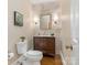 Stylish half bathroom with wood vanity, marble countertop, and decorative mirror at 4026 Sharon View Rd, Charlotte, NC 28226