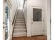 Bright stairway with carpeted steps and wooden handrail, leading to the upper level at 4026 Sharon View Rd, Charlotte, NC 28226