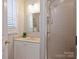 This bathroom has tiled walls, a glass enclosed shower, and vanity with storage at 416 Queens Rd # 10, Charlotte, NC 28207