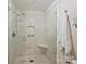 Bathroom features a glass enclosed shower with neutral tiling and built in seat at 416 Queens Rd # 10, Charlotte, NC 28207
