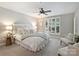 This bedroom features a ceiling fan, shuttered windows, and neutral decor at 416 Queens Rd # 10, Charlotte, NC 28207