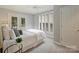 This cozy bedroom features carpeted floors, plantation shutters, and a ceiling fan at 416 Queens Rd # 10, Charlotte, NC 28207