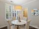 Charming dining room with hardwood floors, a stylish chandelier, and bright windows with plantation shutters at 416 Queens Rd # 10, Charlotte, NC 28207