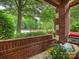 This front porch area features brick columns and a brick wall surrounding the front porch at 416 Queens Rd # 10, Charlotte, NC 28207