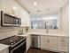 Updated kitchen featuring stainless steel appliances, modern lighting, and seamless connection to the living room at 416 Queens Rd # 10, Charlotte, NC 28207