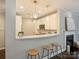 Modern kitchen featuring white cabinets, quartz countertops, stainless steel appliances, and barstool seating at 416 Queens Rd # 10, Charlotte, NC 28207
