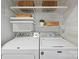 The laundry room offers front loading washer/dryer units and convenient shelf storage at 416 Queens Rd # 10, Charlotte, NC 28207