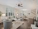 Spacious living room featuring hardwood floors, plantation shutters, modern furnishings, and ample natural light at 416 Queens Rd # 10, Charlotte, NC 28207