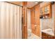 Bathroom with plywood wall covering, a shower with a white curtain, and tiled floors at 417 Phifer Rd, Kings Mountain, NC 28086