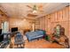 Spacious bedroom featuring wood paneling, a ceiling fan, and a comfortable bed at 417 Phifer Rd, Kings Mountain, NC 28086
