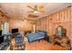 Spacious bedroom featuring wood paneling, a ceiling fan, and a comfortable bed at 417 Phifer Rd, Kings Mountain, NC 28086