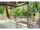 Relaxing deck with wooden furniture, a hammock, and a view of the trees at 417 Phifer Rd, Kings Mountain, NC 28086