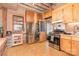 Functional kitchen features wooden cabinets, appliances, and view into other rooms, making meal preparation convenient at 417 Phifer Rd, Kings Mountain, NC 28086