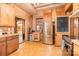 Rustic kitchen with stainless steel appliances, wood cabinets, and a vintage-style interior door at 417 Phifer Rd, Kings Mountain, NC 28086