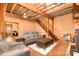 Spacious living room features exposed beam ceiling, wood paneled walls, comfortable seating, and stairs at 417 Phifer Rd, Kings Mountain, NC 28086