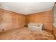 Living Room boasts wood paneling, carpet, and is brightly lit with natural light at 417 Phifer Rd, Kings Mountain, NC 28086
