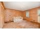 Living Room with wood paneling, closet, carpet, sofa, and window at 417 Phifer Rd, Kings Mountain, NC 28086