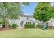 Spacious backyard offers a patio area, lush grass, and a charming play structure with a slide at 5092 Nighthawk Dr, Indian Land, SC 29707