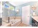 Bright bathroom features a soaking tub with tile surround and a separate glass-enclosed shower at 5092 Nighthawk Dr, Indian Land, SC 29707
