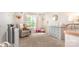 Neutral Bedroom with a rocking chair, changing table, and playful decor at 5092 Nighthawk Dr, Indian Land, SC 29707