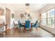 Inviting dining room boasts wood floors, natural light, and a chic chandelier at 5092 Nighthawk Dr, Indian Land, SC 29707