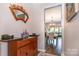 Inviting entryway with decorative mirror, wood cabinet, and a glimpse into the adjacent dining room at 5092 Nighthawk Dr, Indian Land, SC 29707