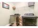 Efficient laundry room with modern washer and dryer and shelving at 5092 Nighthawk Dr, Indian Land, SC 29707