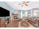 Cozy living room with a stone fireplace, ceiling fan, and comfortable seating arrangement at 5092 Nighthawk Dr, Indian Land, SC 29707