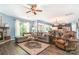 Open-concept living area with fireplace, ceiling fan, and seamless flow to the kitchen and dining area at 5092 Nighthawk Dr, Indian Land, SC 29707