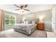 Bright main bedroom with a large window, patterned bedding, and accent furniture at 5092 Nighthawk Dr, Indian Land, SC 29707