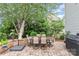 Back patio with a table, seating and a shade umbrella with brick pavers at 5092 Nighthawk Dr, Indian Land, SC 29707
