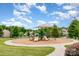 Neighborhood playground with ample play space and walking path surrounded by trees at 5092 Nighthawk Dr, Indian Land, SC 29707