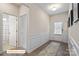 Inviting entryway featuring wood-look floors, white trim, and access to the bathroom at 523 Hullview Vis, Monroe, NC 28110
