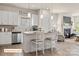 Kitchen boasts an island with seating, white cabinetry, and stainless steel appliances at 523 Hullview Vis, Monroe, NC 28110