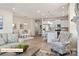 Open-concept living room flows into a modern kitchen with white cabinetry and stainless steel appliances at 523 Hullview Vis, Monroe, NC 28110