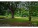 Large backyard with a peaceful gazebo surrounded by trees at 535 Norman Fair Ave, Lincolnton, NC 28092