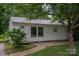Quaint house with white siding, metal roof, and landscaping around it at 535 Norman Fair Ave, Lincolnton, NC 28092