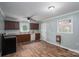 Cozy kitchen featuring wood cabinets, modern countertops, stainless steel appliances, and wood-look floors at 535 Norman Fair Ave, Lincolnton, NC 28092