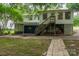 Two-story home with back door, wooden stairs, and carport area at 535 Norman Fair Ave, Lincolnton, NC 28092