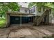 White, two-story home with carport, wooden stairs, and partial basement at 535 Norman Fair Ave, Lincolnton, NC 28092