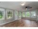 Bright sunroom with wood-look floors, whitewashed paneling, and multiple windows, with a ceiling fan at 535 Norman Fair Ave, Lincolnton, NC 28092