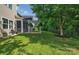 A lush backyard featuring a screened-in porch and a charming pergola, perfect for outdoor enjoyment at 6004 Trailwater Rd, Charlotte, NC 28278
