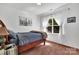 Cozy bedroom boasts natural light, a comfortable bed, and soothing neutral tones at 6004 Trailwater Rd, Charlotte, NC 28278