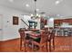 Open dining room with wood table and chairs next to an open kitchen, creating a cozy and inviting atmosphere at 6004 Trailwater Rd, Charlotte, NC 28278