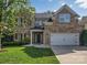 Charming brick two-story home featuring a two-car garage and well-manicured lawn in a lovely neighborhood at 6004 Trailwater Rd, Charlotte, NC 28278