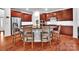 Modern kitchen with wood cabinets, a granite island, stainless steel appliances, and hardwood flooring at 6004 Trailwater Rd, Charlotte, NC 28278