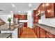 Beautiful kitchen featuring wood cabinetry, a granite island, stainless appliances, and tiled backsplash at 6004 Trailwater Rd, Charlotte, NC 28278