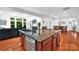 Spacious kitchen featuring an island with granite countertops and stainless steel appliances, open to the living area at 6004 Trailwater Rd, Charlotte, NC 28278