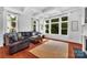 Bright, airy living room features large windows, neutral tones, and a comfortable seating area at 6004 Trailwater Rd, Charlotte, NC 28278