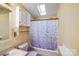 Compact bathroom with a shower-tub combo, cabinet storage, and functional design at 6010 Old Pageland Marshville Rd, Marshville, NC 28103